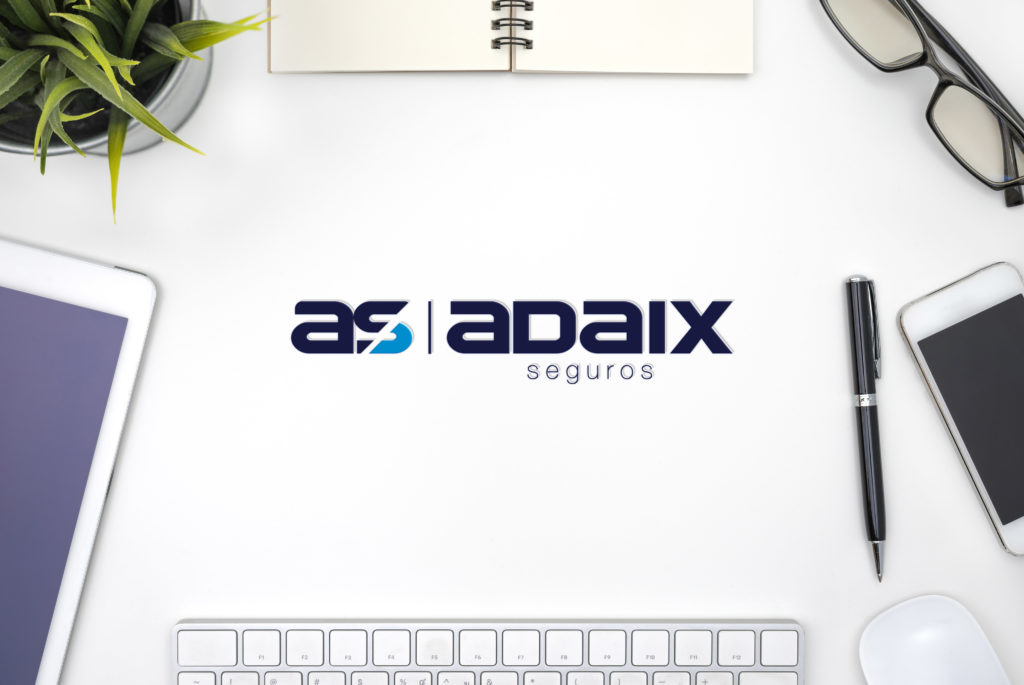 Frame with office equipment on white desk Adaix Seguros
